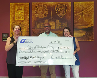 Peachtree City receives a check from Home Depot Government Solutions. 