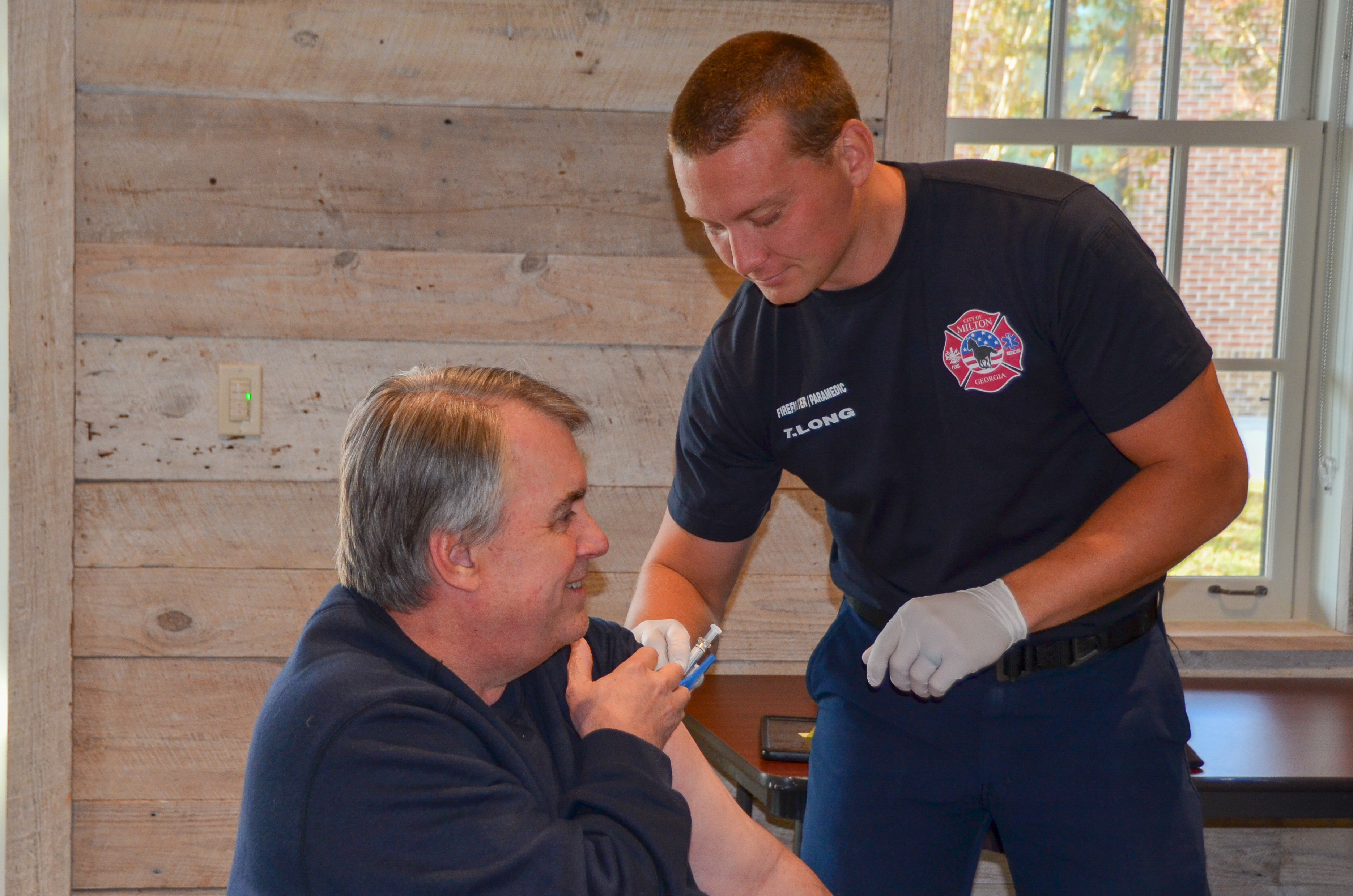A member of the C.A.R.E.S. team gives a shot to a patient. 