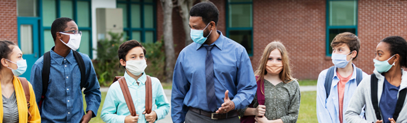 Photo of teacher walking with students.