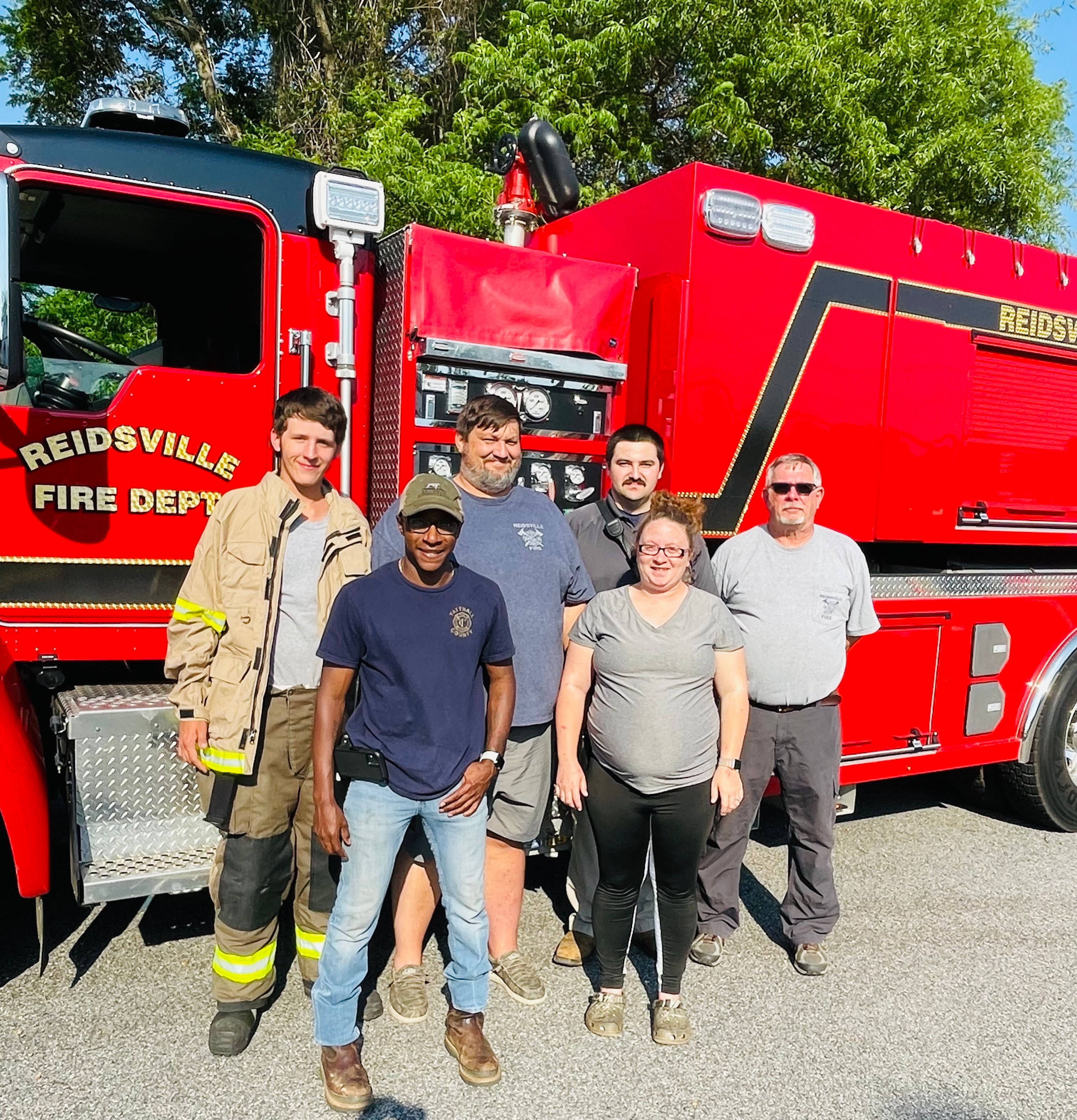 City fire crew next to fire truck. 