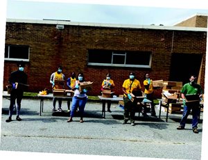 East Point city employees prepare food for distribution. 